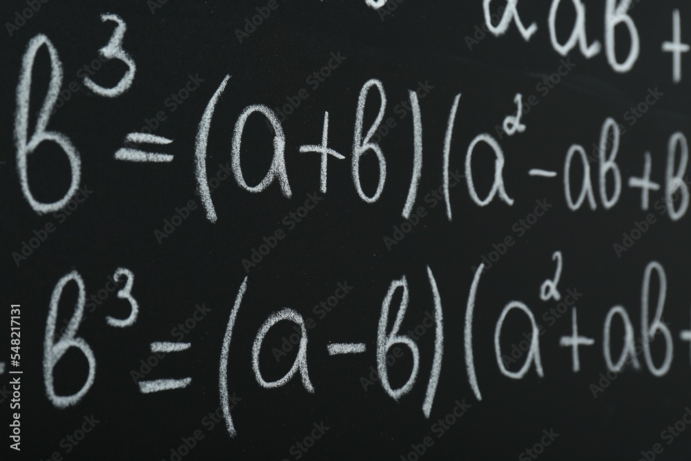 Many different math formulas written on chalkboard, closeup Many different math formulas written on chalkboard, closeup