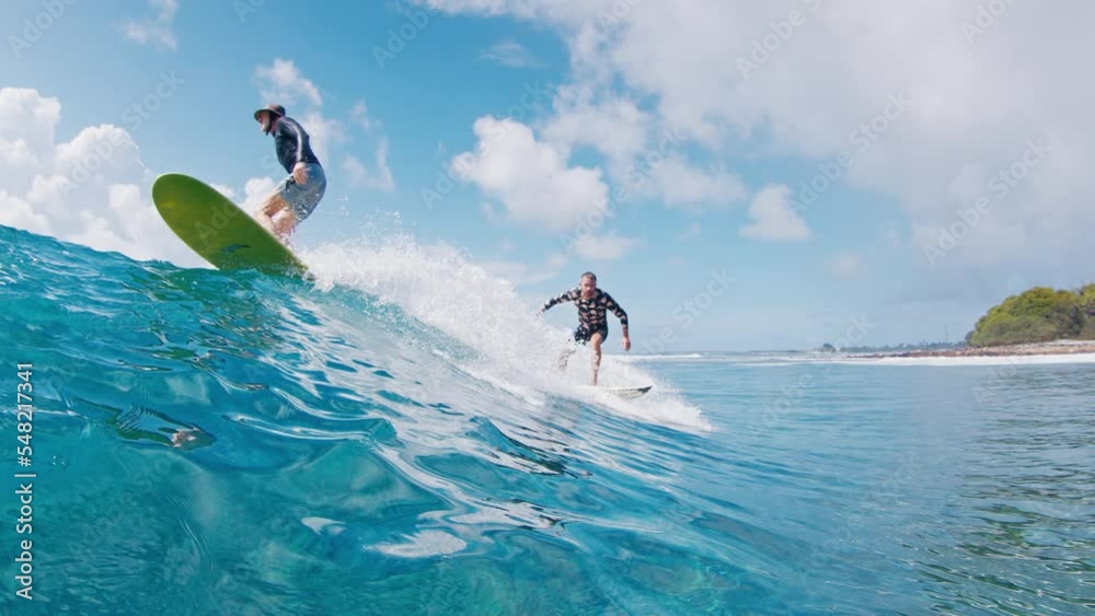 Surfing etiquette. Surfer drops in another rider on the wave and goes away