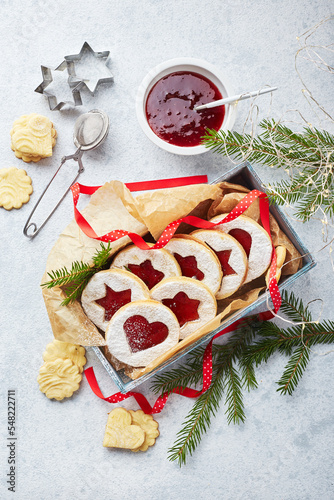 Classic Linzer Christmas Cookies with raspberry or strawberry jam on light background. photo