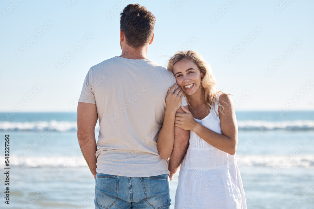 Couple, hug and love for travel, beach or summer vacation relaxing or bonding together in the outdoors. Woman holding man in loving embrace with smile for happy relationship or traveling by the ocean