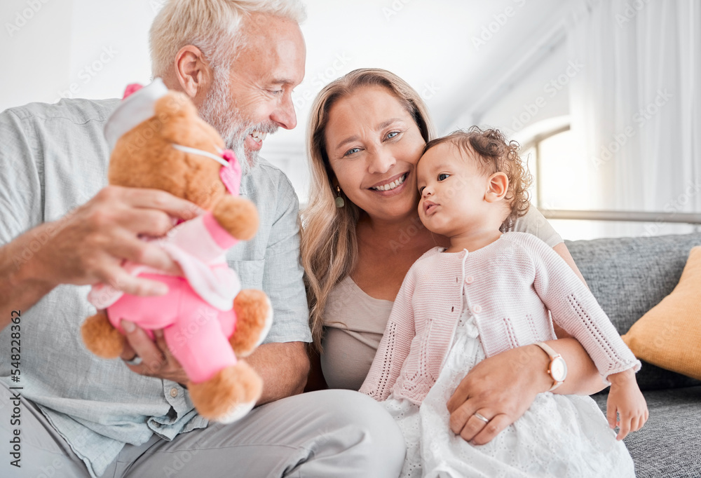 Children, family and teddy bear with a girl and grandparents playing on the sofa during a visit in their home. Kids, love and toys with a senior man and woman bonding together with their grandchild