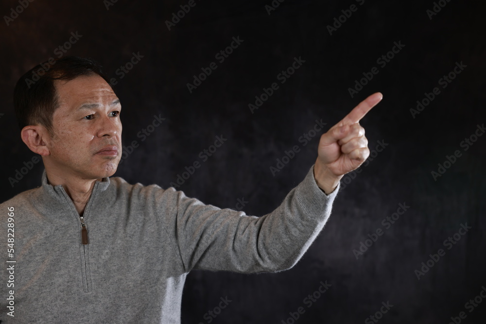 Middle-aged Japanese man in gray turtleneck wool sweater. Concept image of Warm Biz, stability in daily life, and sustainable living. Middle-aged Japanese man in gray turtleneck wool sweater. Concept image of Warm Biz, stability in daily life, and sustainable living.