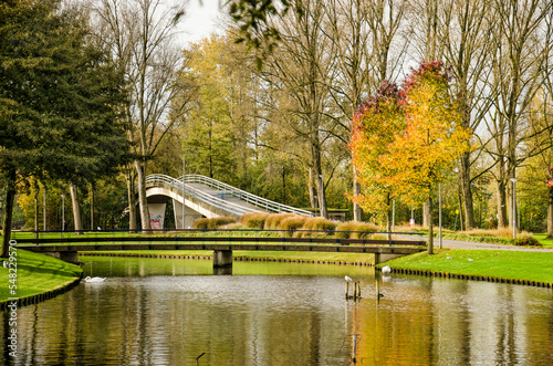 Rotterdam, The Netherlands, November 5, 2022: two pedestrian bridges, one across a pond and one across a road in Zuiderpark in autumn