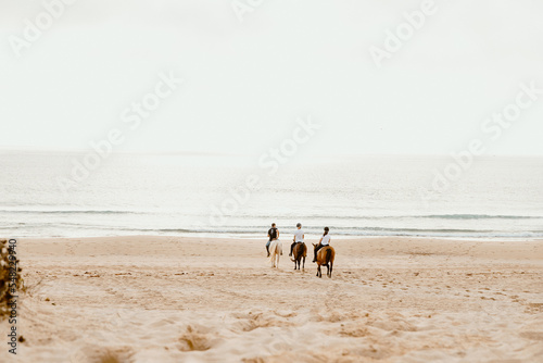 Horseback riding on Supertubos beach at the end of the day, with little fog, in Atouguia da Baleia and close to Peniche, in the western region of Central Portugal.