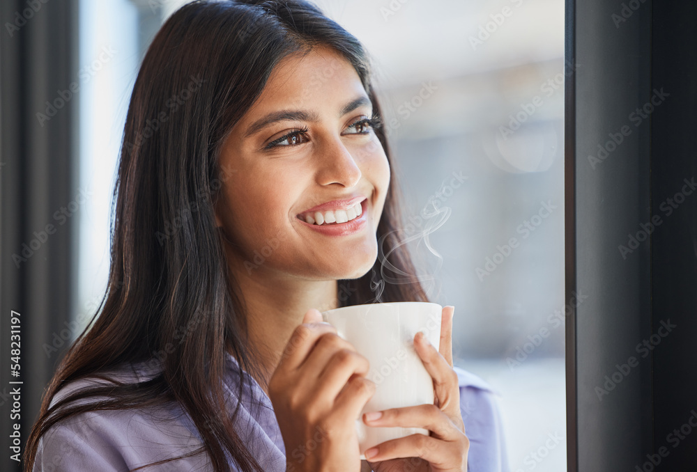 Happy, woman and coffee at a window for relax, thinking and daydream about future, goal and ideas in her home. Face, tea and indian girl smile in her living room, enjoy calm drink and window view Happy, woman and coffee at a window for relax, thinking and daydream about future, goal and ideas in her home. Face, tea and indian girl smile in her living room, enjoy calm drink and window view