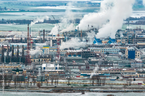 winter aerial panoramic view on smoke of pipes of chemical enterprise plant. Industrial landscape environmental pollution waste plant. Air pollution concept.
