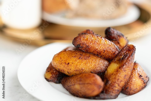 Closeup of fried sweet plantains on a plate. photo