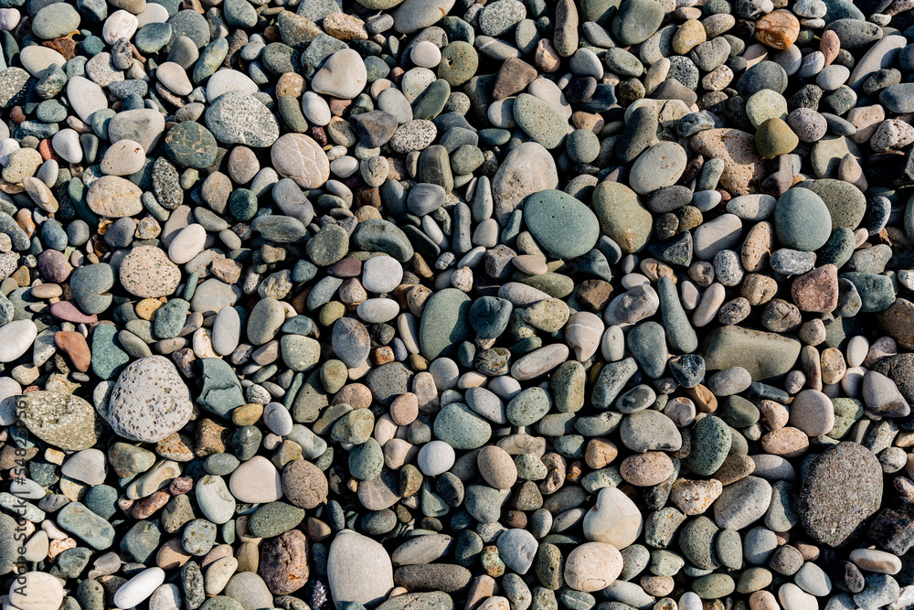 Small round stones background. Stone texture. Rough surface of small pebble stone. Small round stones background. Stone texture. Rough surface of small pebble stone.
