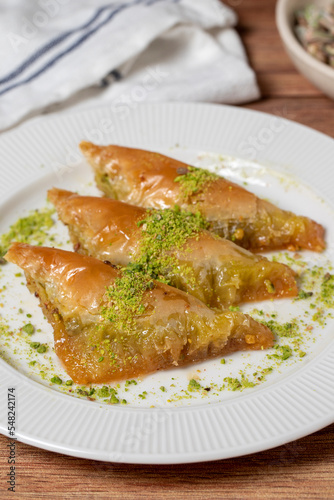 Sobiyet baklava with pistachio on wooden background. Turkish cuisine delicacies. Turkish baklava. close up