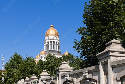 Construction of patriarchal Eastern Orthodox People's Salvation Cathedral (Catedrala Mantuirii Neamului) with gilded Domes, behind a strong concrete fence, Parliment complex part, Bucharest, Romania photo