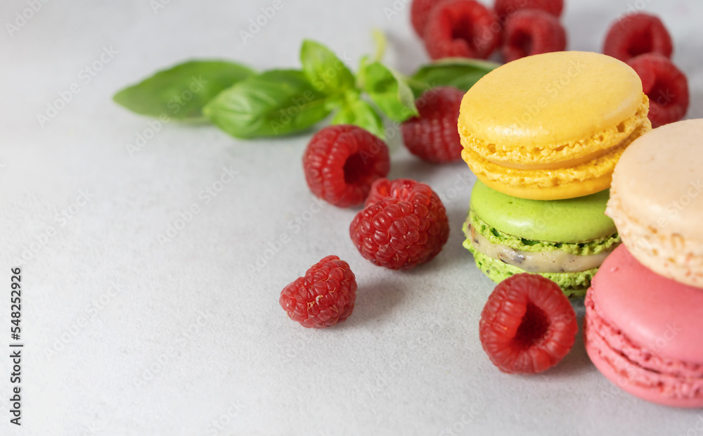 Fruity Macaroons, macarons with Raspberries on a gray background with copy space. Confectionery with berries. Fruity Macaroons, macarons with Raspberries on a gray background with copy space. Confectionery with berries.