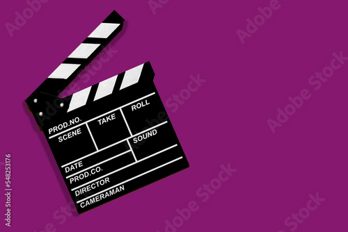Movie clapperboard for shooting videos and movies on a purple background copy space