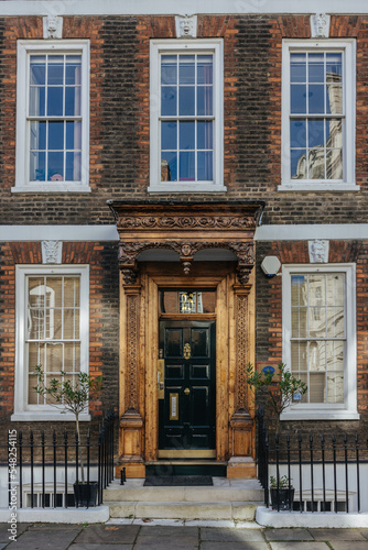 Beautiful old brick building facade and entrance door in London  England