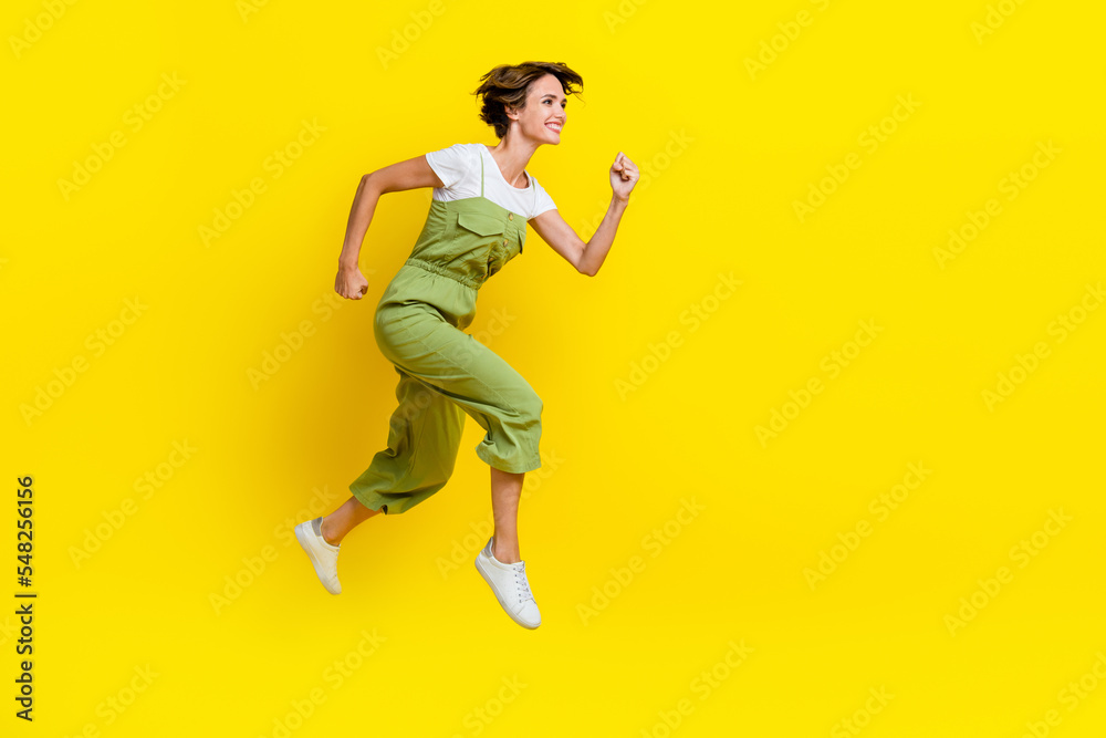 Profile body size photo of youngster playful girl fast runner empty space jump air deadline for weekend empty space isolated on yellow color background