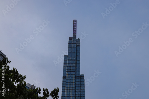 Ho Chi Minh City  Vietnam - November 08  2022  Landmark 81  a building in Saigon. Landmark 81 among other high-rise buildings of Vinhomes Central Park urban area with a lawn and palm tree alley