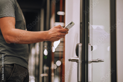 Datacenter worker opening the door using his smartphone