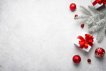 Merry Christmas and Happy Holidays greeting card, frame, banner. New Year. Noel. Christmas red ornaments and gift on light background top view. Winter xmas holiday theme. Flat lay	

