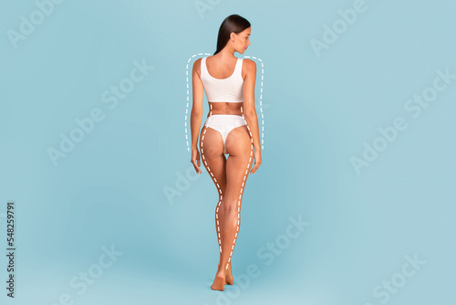 Rear view of slim woman in underwear with dashed lines on body photo