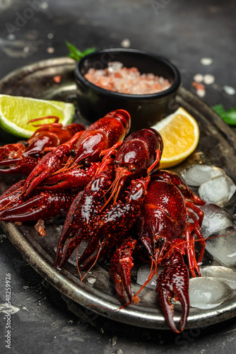 Red boiled crayfish crawfish ready to eat, beer appetizer, on a metal tray, on a dark background Fototapet