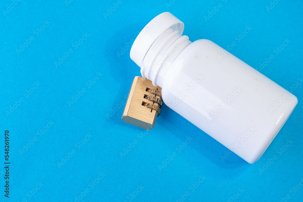 white pain killer can locked with a lock on blue white pain killer can locked with a lock on blue