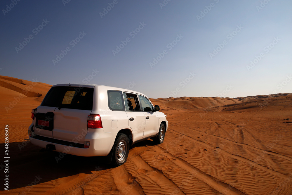 Off road vehicle on sand dunes, Oman