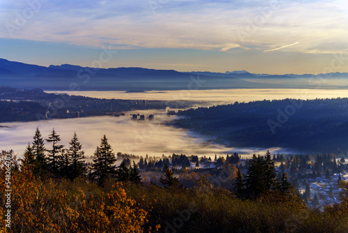 Upper floors of high-rise condominiums poking through Fall cloud inversion over Fraser Valley, BC, Canada 