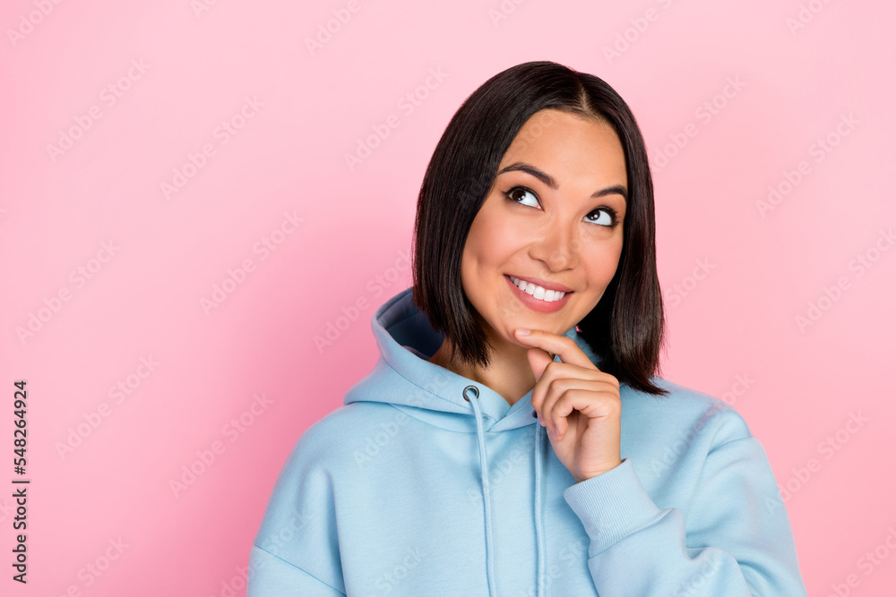 Photo of cheerful cute pretty lady wear stylish sweatshirt interested look empty space cool proposition isolated on pink color background Photo of cheerful cute pretty lady wear stylish sweatshirt interested look empty space cool proposition isolated on pink color background