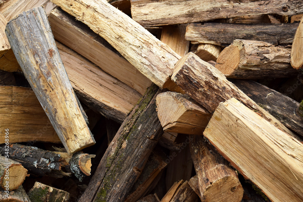 Lots of chopped oak firewood. Natural background. Lots of chopped oak firewood. Natural background.