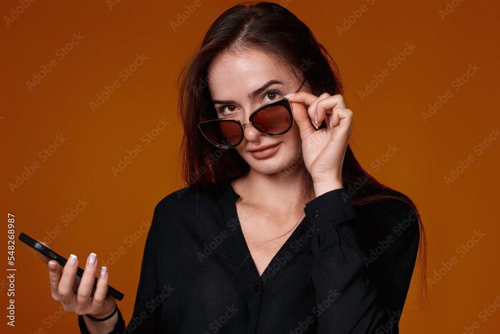woman in black shirt and jeans using mobile cell phone woman in black shirt and jeans using mobile cell phone