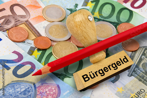 Bürgergeld und Euro Geldscheine, Münzen, roter Stift und Stempel photo