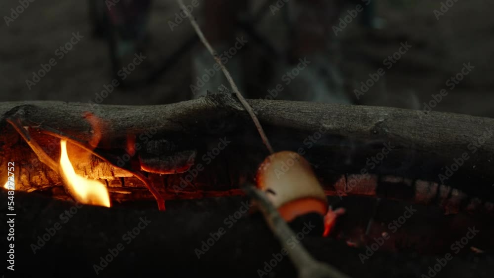 we fry marshmallows on the beach, an evening picnic by the sea. the camera moves around the campfire. Slow motion we fry marshmallows on the beach, an evening picnic by the sea. the camera moves around the campfire. Slow motion