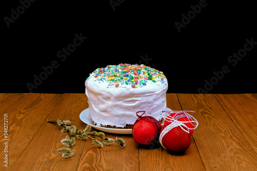 Homemade Easter cake. White glaze.bread pie, cake. decorated with sweets. on a rustic wooden background. with Easter red eggs. spring flowers. happy Easter.mea 