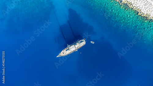 Drone footage of a boat in the cristal clear sea © Erkut