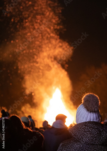 Crowds watching a roaring bonfire on firework's night in November at Bicester, Oxfordshire