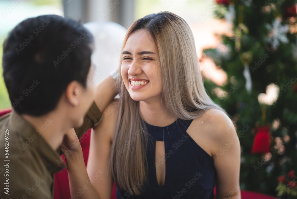 Naklejka premium Two Asian young people cute couple husband guy wife lady drink hot beverage x-mas eve spend time magic land newyear, Christmas celebrate in romantic love together with family, happy holiday concept