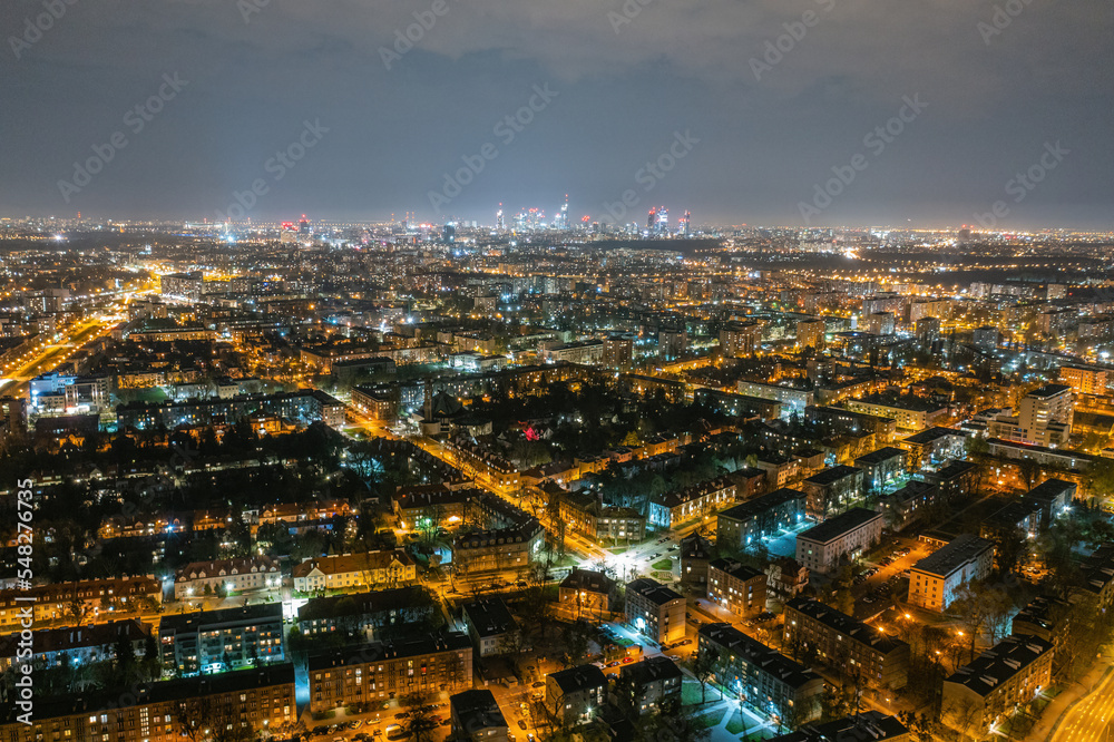 Obraz premium Warsaw by night, aerial landscape of illuminated streets and buildings