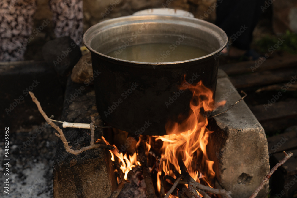 The cauldron over the wood fire The cauldron over the wood fire