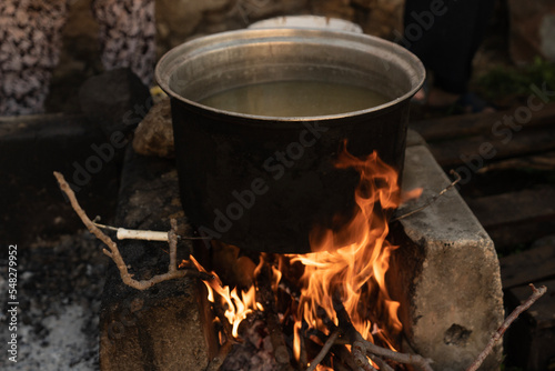 The cauldron over the wood fire