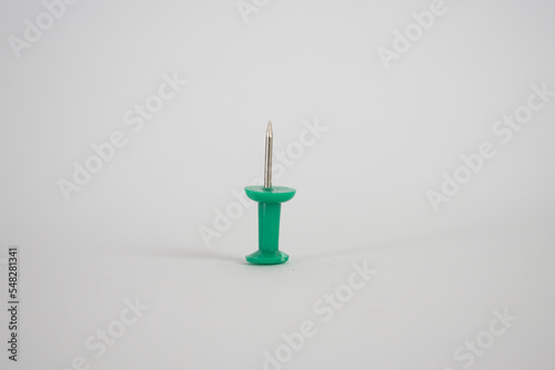 Green thumbtack pushpin close up white background