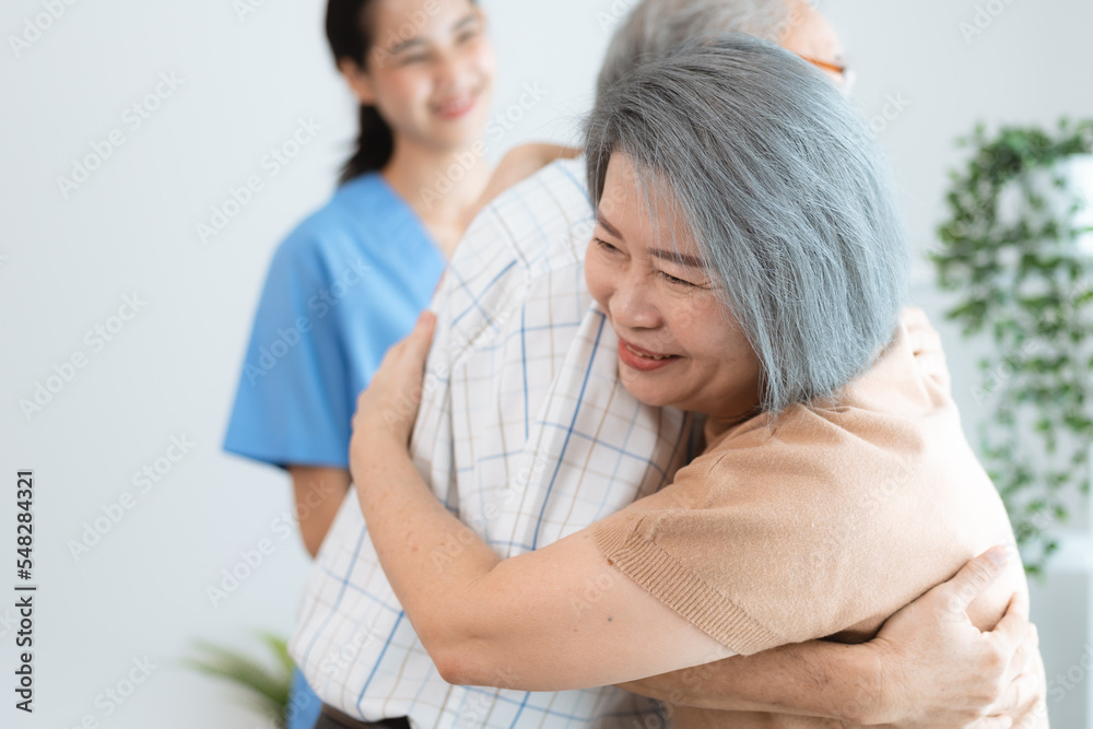 Portrait of happy senior couple with wife embracing husband, nurse doctor senior care caregiver help assistance retirement at home nursing, or hugging after sick in hospital Portrait of happy senior couple with wife embracing husband, nurse doctor senior care caregiver help assistance retirement at home nursing, or hugging after sick in hospital