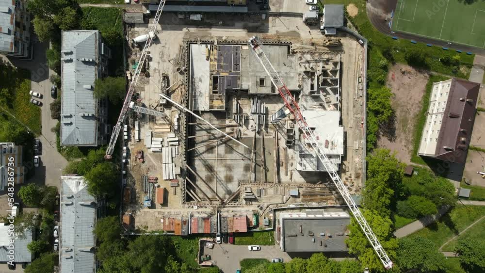 Tower crane turning over construction site aerial view Tower crane turning over construction site aerial view