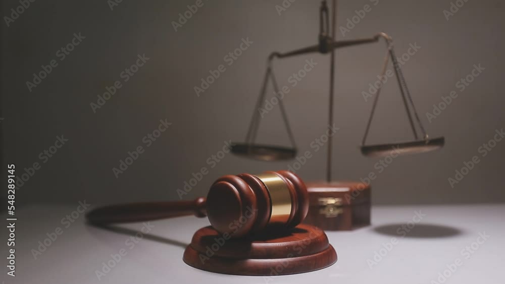 Business and lawyers discussing contract papers with brass scale on desk in office. Law, legal services, advice, justice and law concept picture with film grain effect Business and lawyers discussing contract papers with brass scale on desk in office. Law, legal services, advice, justice and law concept picture with film grain effect