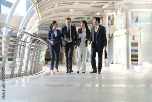 Business people walking and talk to each other in front of modern office