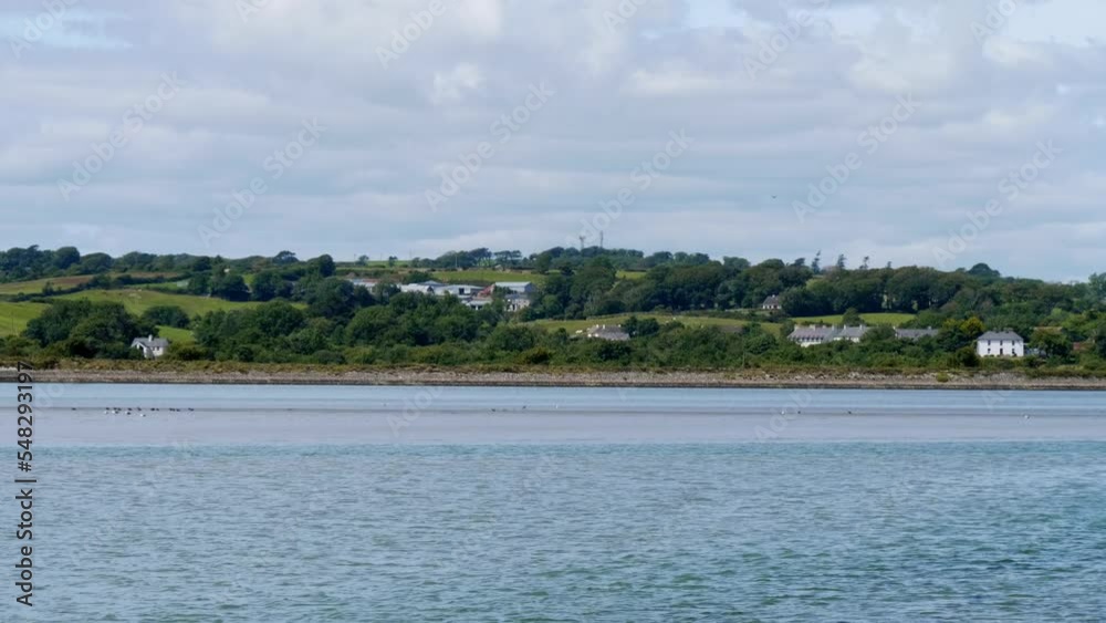 Houses on the coast in Ireland, coastal landscape. The Irish coast on a sunny day under a clear sky. Landscape. Houses on the coast in Ireland, coastal landscape. The Irish coast on a sunny day under a clear sky. Landscape.