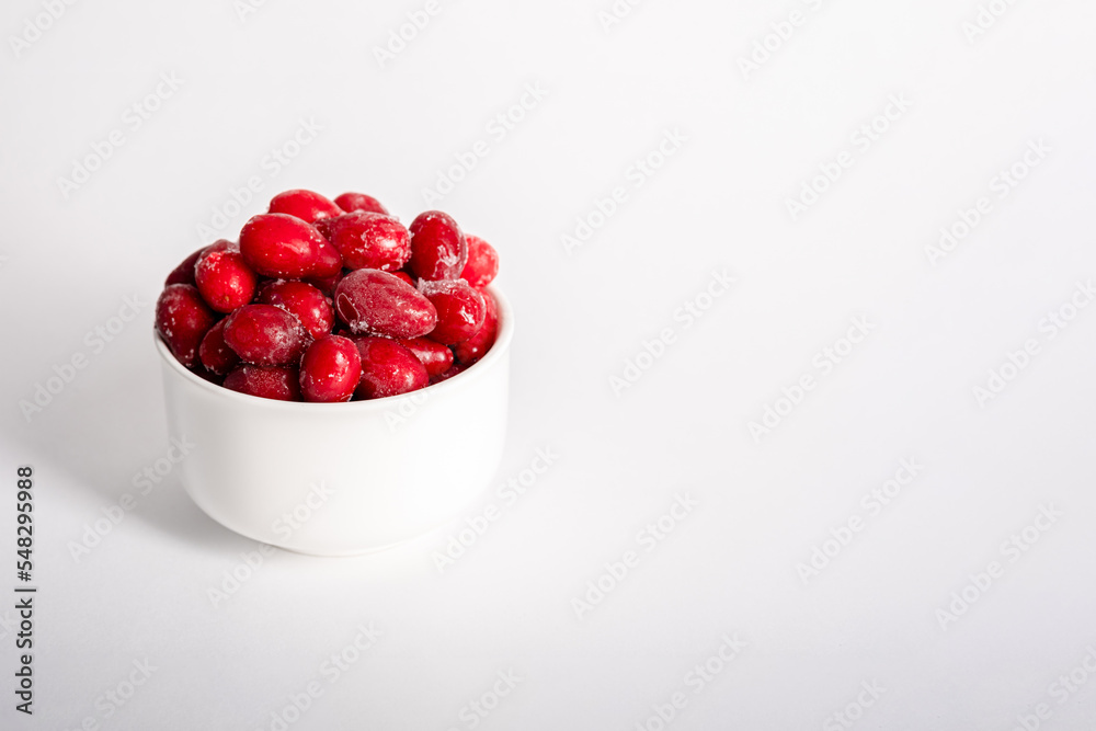 Frozen berry of fresh dogwood on a white, light background. Whole dogwood berries for compote Frozen berry of fresh dogwood on a white, light background. Whole dogwood berries for compote