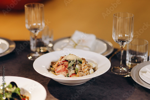 Decorating the festive table. Serving plates and glasses.