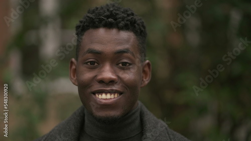 Smiling happy black African man standing outdoors during winter season