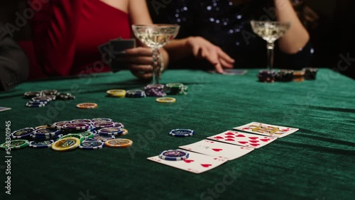 Extreme close-up of poker cards, player checking his hand before making bet. Casino customer playing at table, winning combination strategy, gambling fortune. Lucky tournament winner looking at pair