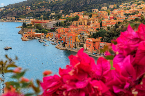 Villefranche sur Mer medieval town in South of France with bougainvillea blossom