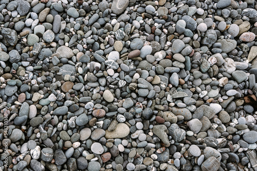 Abstract background with black and gray round sea pebble stones